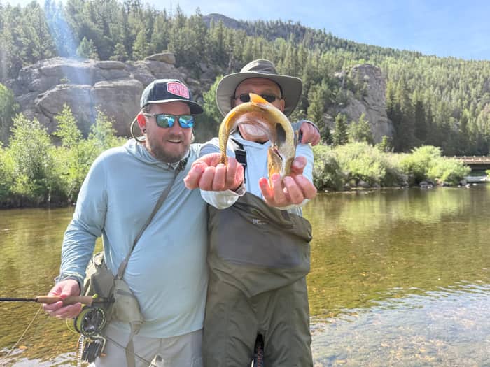 Cole Atchley and a client with a trout on a Colorado river